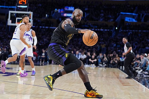 Los Angeles Lakers forward LeBron James (23) goes after a loose ball during the first half of an NBA basketball game against the Utah Jazz  in Los Angeles.