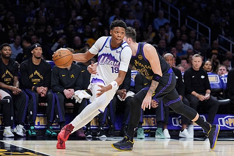 Utah Jazz guard Ace Bailey (19) is pressured by Los Angeles Lakers guard Luka Doncic (77) during the first half of an NBA basketball game in Los Angeles.