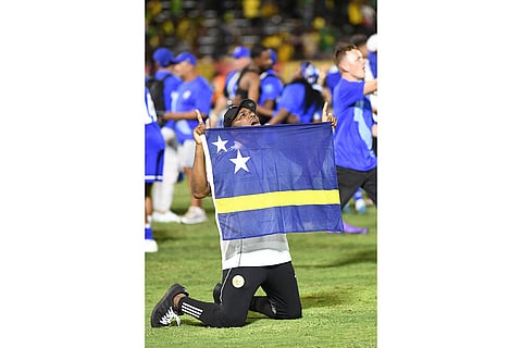 A Curaçao team member celebrates qualifying for the 2026 FIFA World Cup after a soccer match against Jamaica in Kingston, Jamaica.