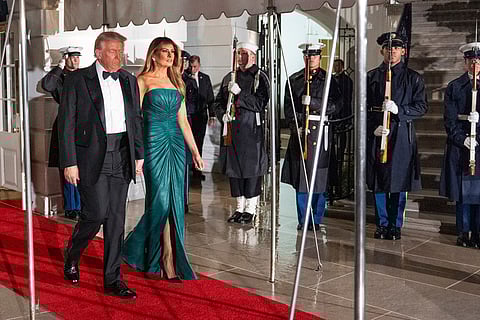 US President Donald Trump and first lady Melania Trump walk to greet Saudi Arabia's Crown Prince Mohammed bin Salman for a dinner at the White House in Washington. 