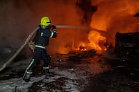 (AP Photo/Andrii Marienko) : Rescue workers put out a fire of a residential building damaged by a Russian strike on Kharkiv, Ukraine, Wednesday, Nov. 19, 2025.