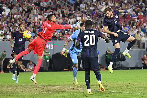 United States' Tanner Tessman (8) scores on Uruguay goalie Cristopher Fiermarin (1) during the second half of an international friendly soccer game in Tampa, Fla.