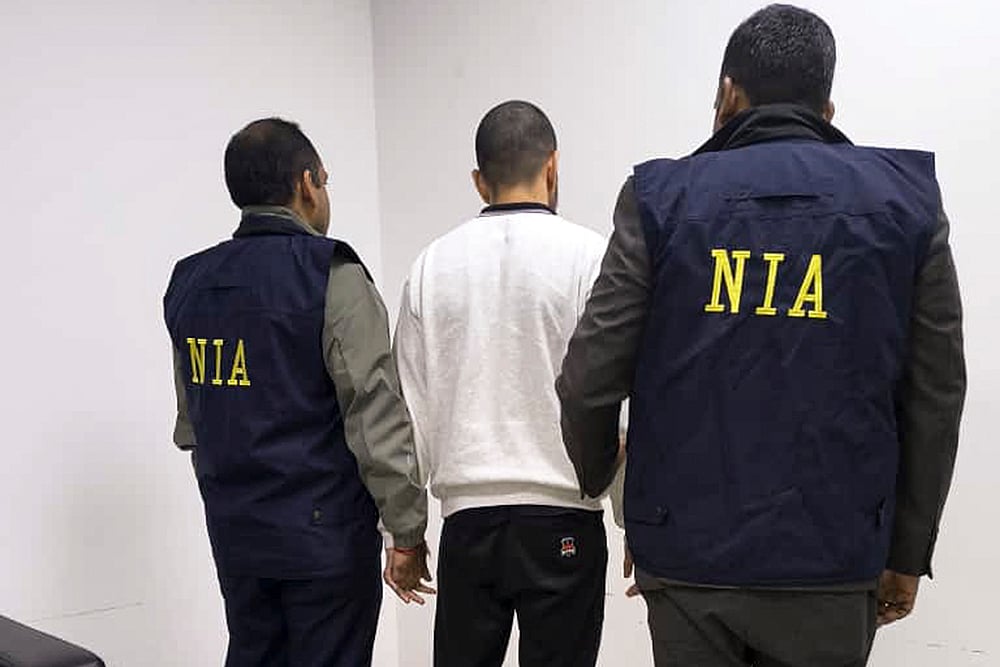 In this image received on Nov. 19, 2025, gangster Anmol Bishnoi, key accused in murder of NCP leader Baba Siddique, accompanied by the National Investigation Agency (NIA) officials during his deportation from the US to India.  - Photo: NIA via PTI 