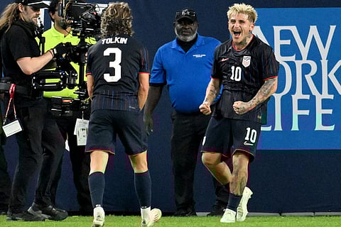 United States' John Tonkin (3) and Diego Luna (10) celebrate Luna's goal during the first half of an international friendly soccer game against Uruguay in Tampa, Fla.