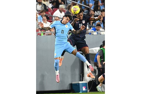 Uruguay's Facundo Torres (21) and United States' Alex Freeman (16) go up for a header during the second half of an international friendly soccer game in Tampa, Fla.