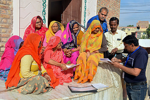 A Booth Level Officer interacts with people about the Special Summary Revision (SSR) of electoral rolls, in Bikaner.
