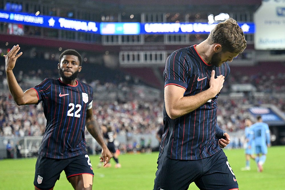 United States' Mark McKenzie (22) and Tanner Tessman celebrate Tessmann's goal during the second half of an international friendly soccer game against Uruguay in Tampa, Fla. - | Photo: AP/Jason Behnken