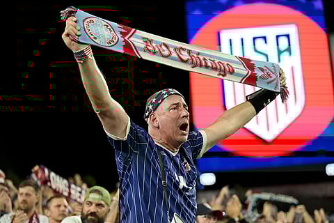 A United States fan cheers on his team following an international friendly soccer game against Uruguay in Tampa, Fla.