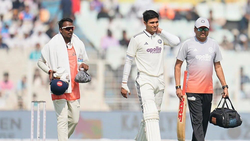 | Photo: AP/Aijaz Rahi : India's captain Shubman Gill, center, leaves the field after retired hurt on the second day of the first cricket test match between India and South Africa in Kolkata.