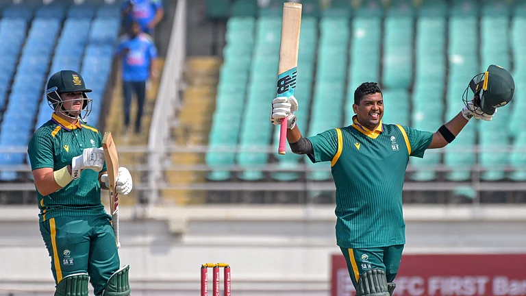 South Africa A's Rivaldo Moonsamy, right, celebrates his century during the third unofficial ODI against India A in Rajkot. - PTI
