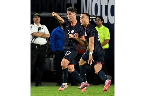 United States' Sebastian Berhalter (17) and Sergino Dest, right, celebrate Berhalter's goal during the first half of an international friendly soccer game against Uruguay in Tampa, Fla. 