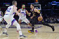 LA Lakers 140-126 Utah Jazz, NBA 2025-26: LeBron James Makes Unprecedented Return | Photo: AP/Jae C. Hong : Los Angeles Lakers guard Luka Doncic (77) is defended by Utah Jazz forward Kevin Love (42) and forward Kyle Anderson (2) during the second half of an NBA basketball game in Los Angeles.