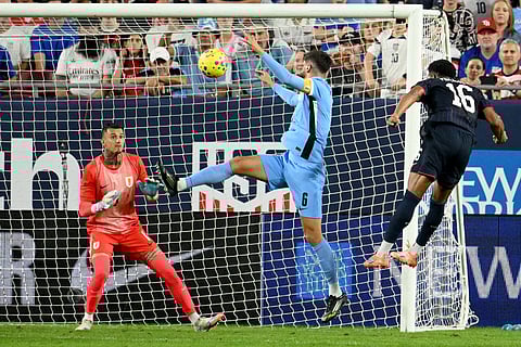 United States' Alex Freeman (16) scores on Uruguay goalie Cristopher Fiermarin (1) as Rodrigo Bentancur (6) defends during the first half of an international friendly soccer game in Tampa, Fla.