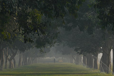 Sprinklers run on the lawns near Kartavya Path amid morning smog as air quality remains in the ‘poor’ category, in New Delhi.