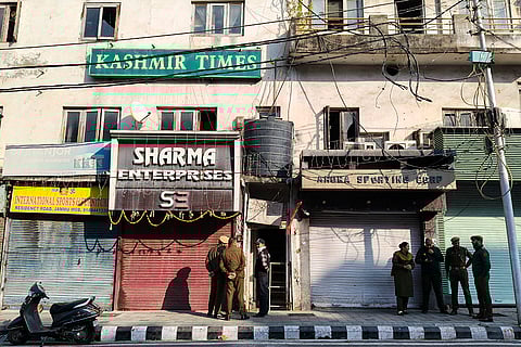 Officials outside the Kashmir Times office during a raid by State Investigation Agency (SIA) as part of an ongoing probe into a terror module case, in Jammu.