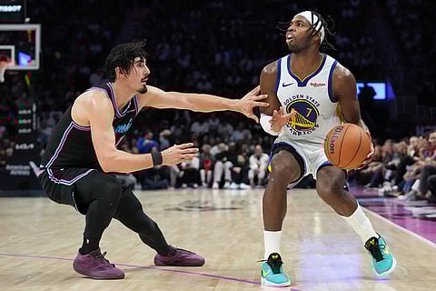 Miami Heat forward Jaime Jaquez Jr., left, defends Golden State Warriors guard Buddy Hield (7) during the second half of an NBA basketball game in Miami. 