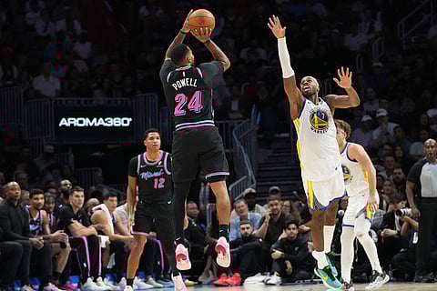 Miami Heat guard Norman Powell (24) shoots as Golden State Warriors guard Buddy Hield, right, defends during the second half of an NBA basketball game in Miami.