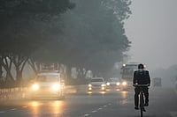 | Photo: PTI/Karma Bhutia : Vehicles ply on a road amid smog as air quality deteriorates, in New Delhi.