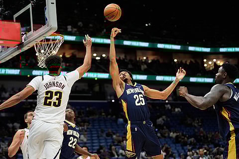 New Orleans Pelicans forward Trey Murphy III (25) battles for a rebound against Denver Nuggets forward Cameron Johnson (23) in the second half of an NBA basketball game in New Orleans. 