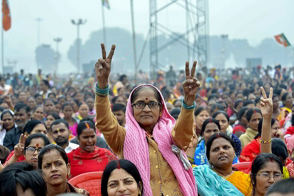 A woman shows a victory sign at Gandhi Maidan during the swearing-in ceremony of NDA government, in Patna, Bihar. - | Photo: PTI