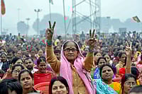 Day In Pics: November 20, 2025 | Photo: PTI : A woman shows a victory sign at Gandhi Maidan during the swearing-in ceremony of NDA government, in Patna, Bihar.
