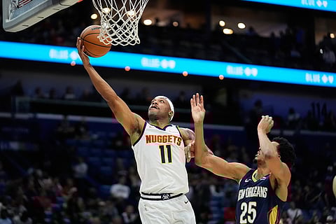 Denver Nuggets guard Bruce Brown (11) goes to the basket over New Orleans Pelicans forward Trey Murphy III (25) in the second half of an NBA basketball game in New Orleans. 