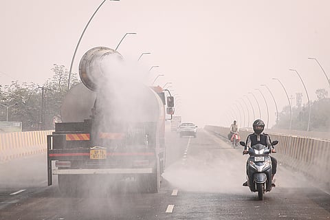 An anti-smog gun sprays water droplets to curb air pollution, in Noida.