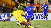 AP Photo/Collin Reid : Curaçao's Juninho Bacuna, center, fight for the ball against Jamaica's Ethan Pinnock, left, during a World Cup 2026 qualifying soccer match in Kingston, Jamaica, Tuesday, Nov. 18, 2025