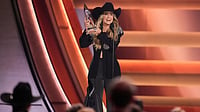 (AP Photo/George Walker IV) : Lainey Wilson receives the award for female vocalist of the year during the 59th Annual Country Music Association Awards on Wednesday, Nov. 19, 2025, at Bridgestone Arena in Nashville, Tenn.