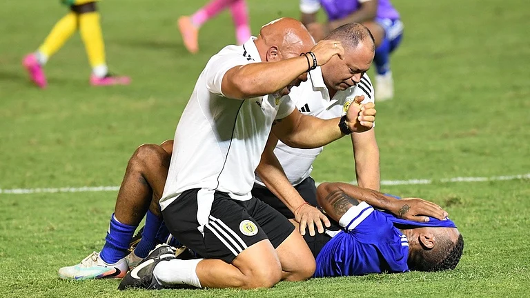Curacao players and trainers celebrate qualifying for the 2026 FIFA World Cup after their game with Jamaica in Kingston. - AP