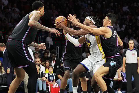 Miami Heat forward Simone Fontecchio, right, defends Golden State Warriors guard Buddy Hield, second from right, during the second half of an NBA basketball game, in Miami. 