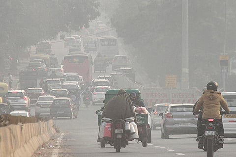 Vehicles move along a road as air quality remains deteriorated, in Gurugram.