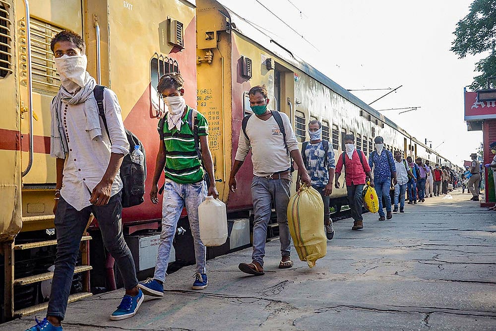 Migrants, arriving by a special train from Godhra in Gujarat, prepare to leave the Danapur Railway Station for their native places, amid ongoing COVID-19 lockdown, in Patna. - | Photo: PTI