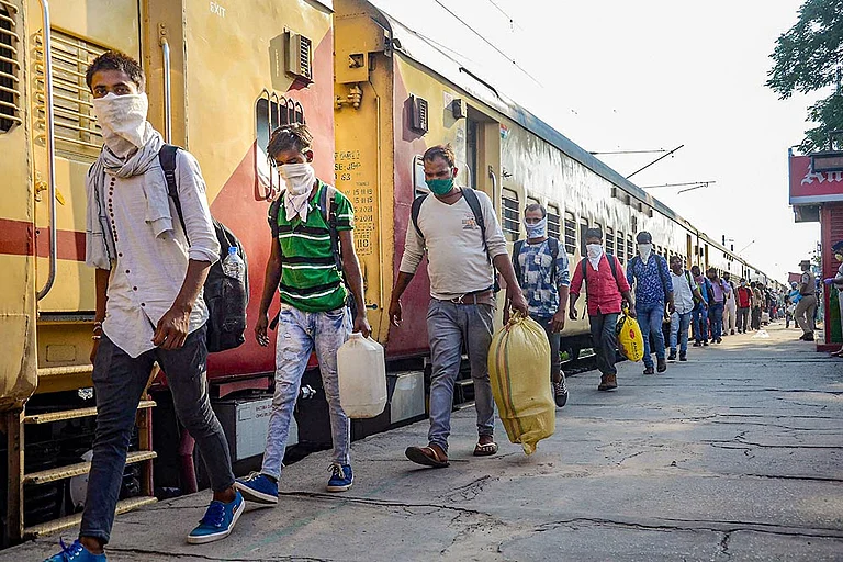 Migrants, arriving by a special train from Godhra in Gujarat, prepare to leave the Danapur Railway Station for their native places, amid ongoing COVID-19 lockdown, in Patna. - | Photo: PTI