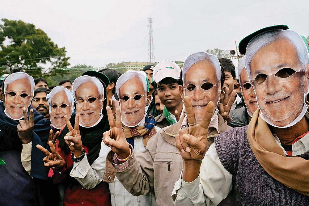 The Loyalists: JD(U) supporters wearing masks of Nitish Kumar at a rally in Gaya - | Photo: PTI