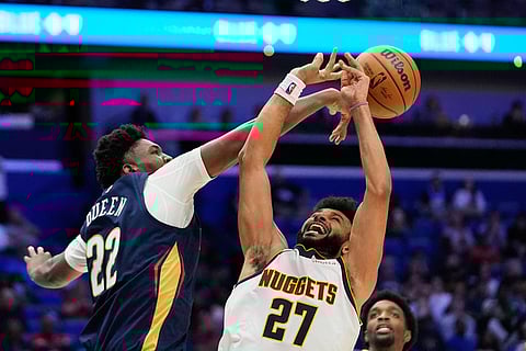 New Orleans Pelicans center Derik Queen (22) blocks a shot by Denver Nuggets guard Jamal Murray (27) in the second half of an NBA basketball game in New Orleans. 