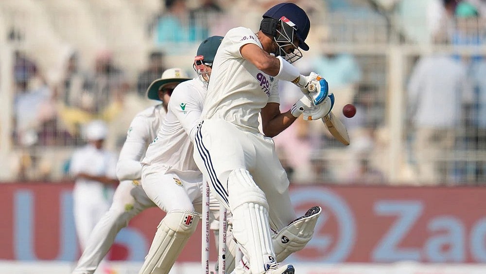 | Photo: AP/Aijaz Rahi : India's Axar Patel plays a shot on the second day of the first cricket test match between India and South Africa in Kolkata.