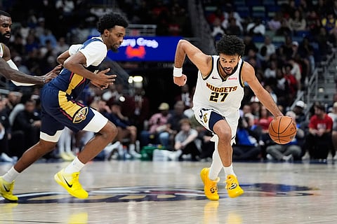 Denver Nuggets guard Jamal Murray (27) races down court past New Orleans Pelicans forward Herbert Jones in the second half of an NBA basketball game in New Orleans. 