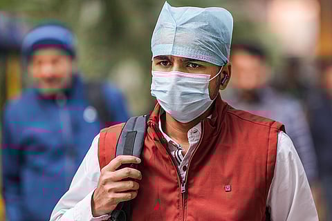 A commuter wears a mask after air quality remains in 'very poor' category, in New Delhi.