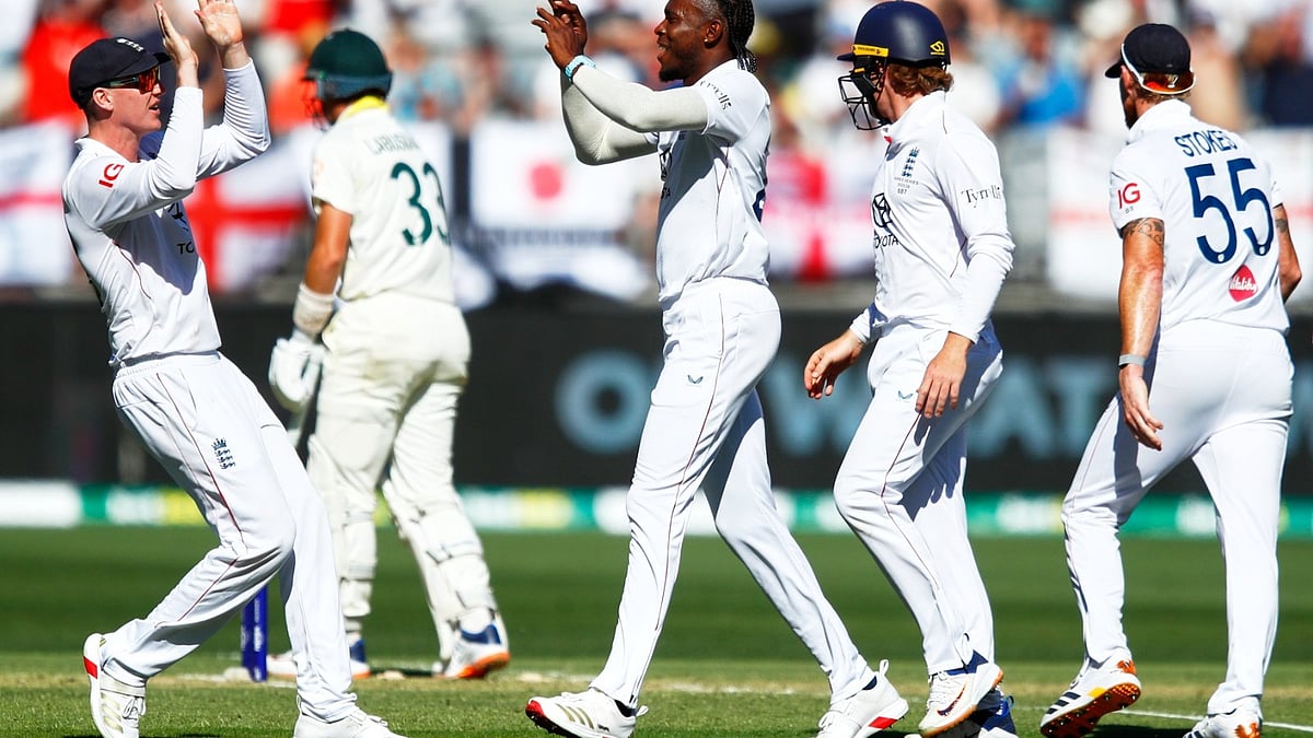 AP Photo/Gary Day : England's Jofra Archer, center, celebrates with teammates the wicket of Australia's Marnus Labuschagne during the first Ashes cricket test match between Australia and England in Perth, Friday, Nov. 21, 2025.
