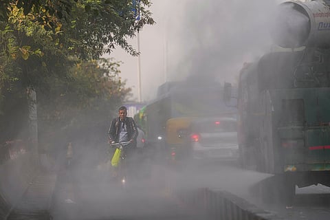 An anti-smog gun sprays water droplets to curb air pollution, in New Delhi.