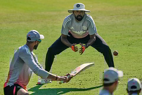 India's Mohammed Siraj takes a catch during a practice session ahead of the second test match between India and South Africa in Guwahati.
