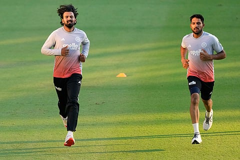 India's K. L. Rahul, left, and Dhruv Jurel run during a practice session ahead of the second test match between India and South Africa in Guwahati.