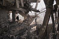 Israel-Gaza Conflict Escalates: Teenagers Killed In East Jerusalem, West Bank Violence Rises (AP Photo/Jehad Alshrafi) : A Palestinian walks through the ruins of a building damaged by an Israeli strike the day before, in Gaza City, Nov. 20, 2025.