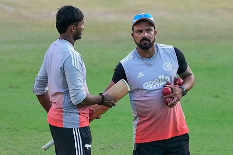 India's Sai Sudharsan, left, and fielding coach T. Dilip talk during a practice session ahead of the second test match between India and South Africa in Guwahati.