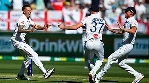 | Photo: AP/Gary Day : England's Brydon Carse, left, celebrates with teammates Ben Stokes and Gus Atkinson the wicket of Australia Usman Khawaja during the first Ashes cricket test match between Australia and England in Perth, Friday, Nov. 21, 2025.