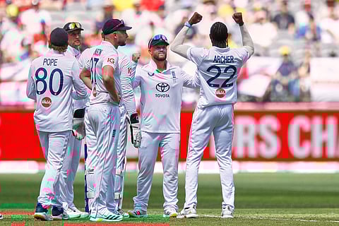 England's Jofra Archer, right, celebrates with teammates the wicket of Australia's Jake Weatherald during the first Ashes cricket test match between Australia and England in Perth.