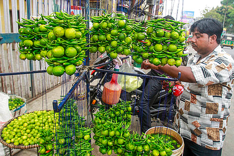 A street vendor arranges 'Nimbu Mirchi', traditional talismans made of a lemon and seven green chilies, believed to ward off the evil eye, bad luck, and negative energy, in Agartala.