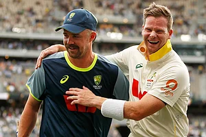 | Photo: AP/Gary Day : Australia's captain Steve Smith, right, and Travis Head celebrate after winning their first Ashes cricket test match against England in Perth.