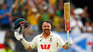 (AP Photo/Gary Day) : Australia's Travis Head celebrates his century on day two of the first Ashes cricket test match between Australia and England in Perth, Saturday, Nov. 22, 2025.